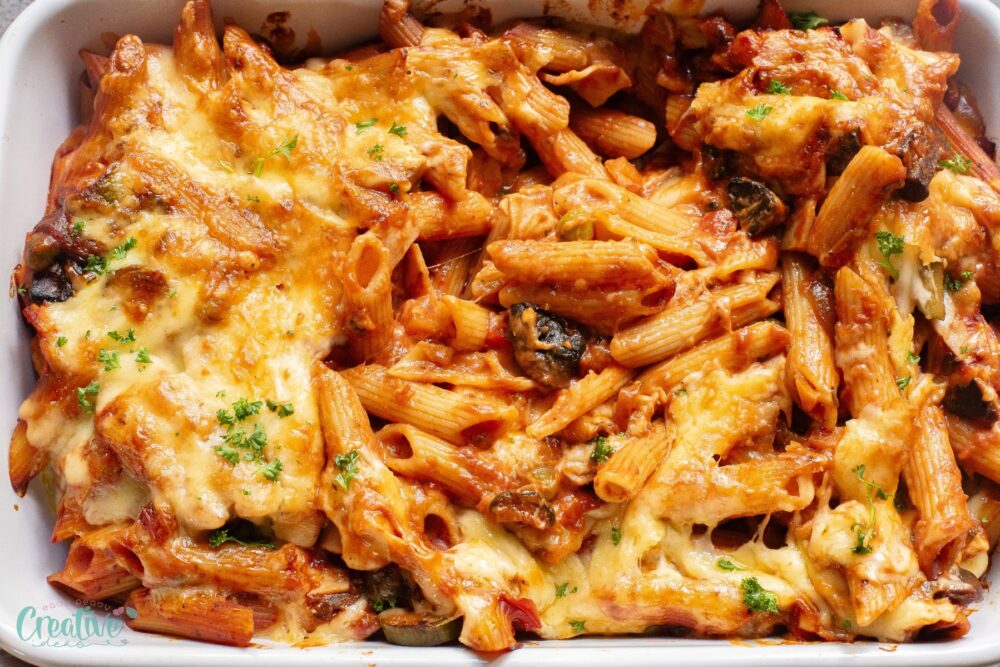 Creamy baked pasta is a delightful blend of flavors and textures. It's the perfect balance of creamy and savory, combining smoky ham with fresh veggies and gooey cheese.